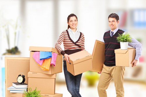 Local movers handling furniture carefully on a Westminster street with access challenges