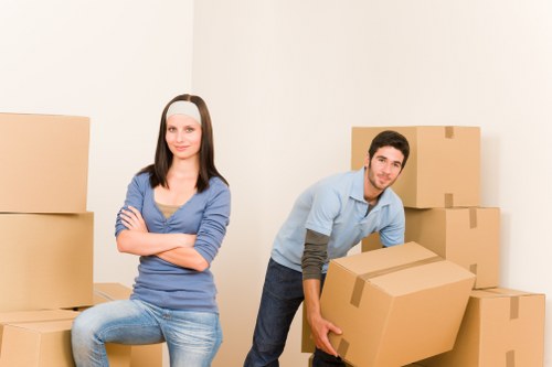 Local movers handling boxes and furniture in a Westminster flat