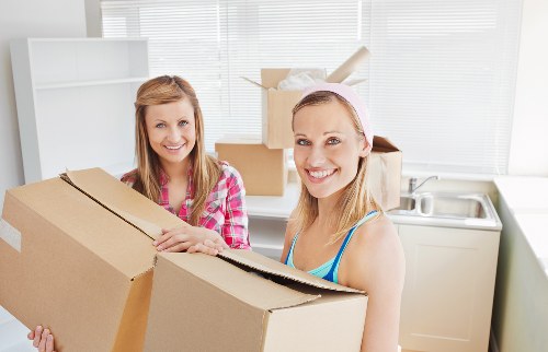 Professional movers handling furniture in a central London apartment building